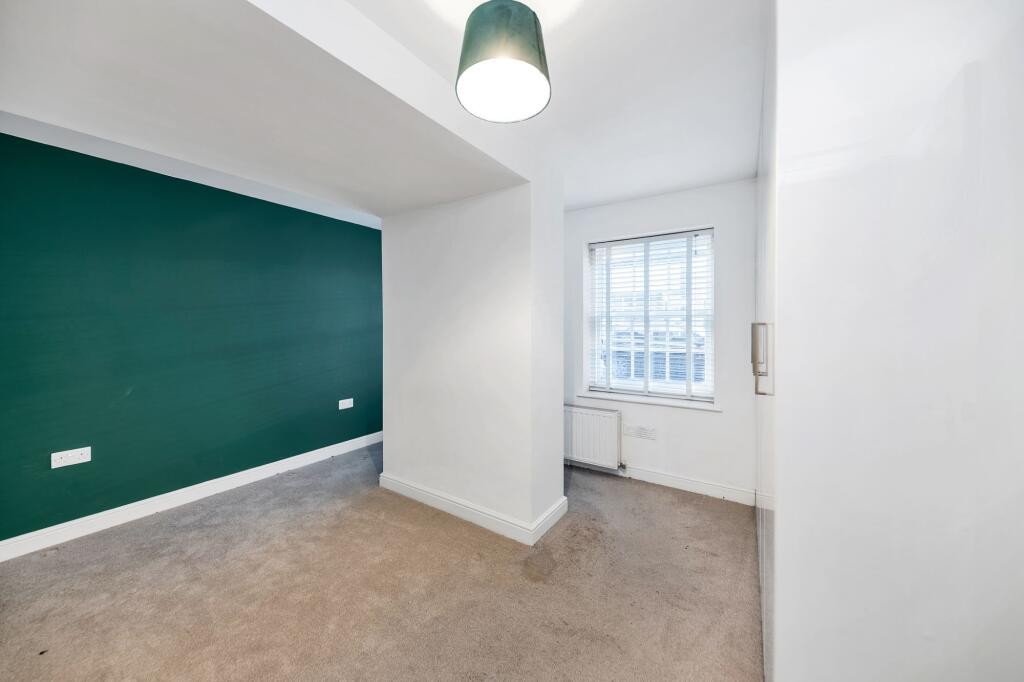 Lot: 79 - GROUND FLOOR FLAT SITUATED ON HIGH STREET - main bedroom with window and fitted wardrobes